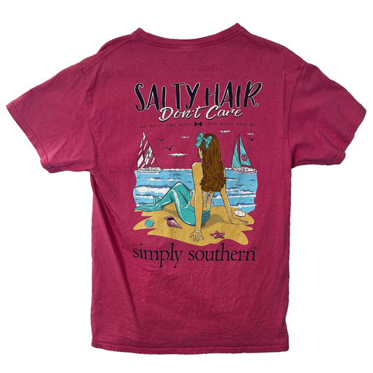Light pink t-shirt with a "Salty Hair Don't Care" wordings and mermaid on beach graphics