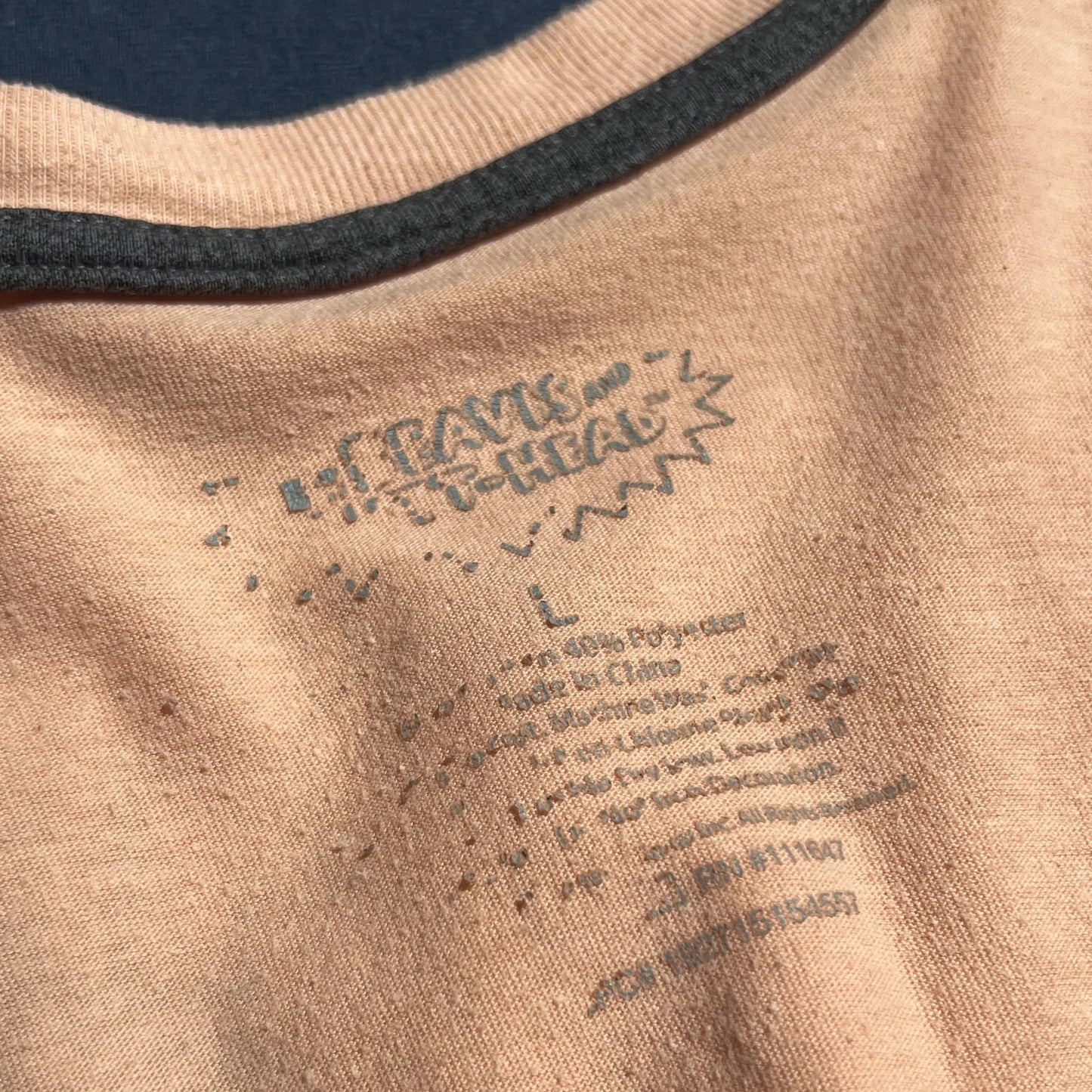 Close-up of Beavis and Butthead Carelabel on beige long sleeve