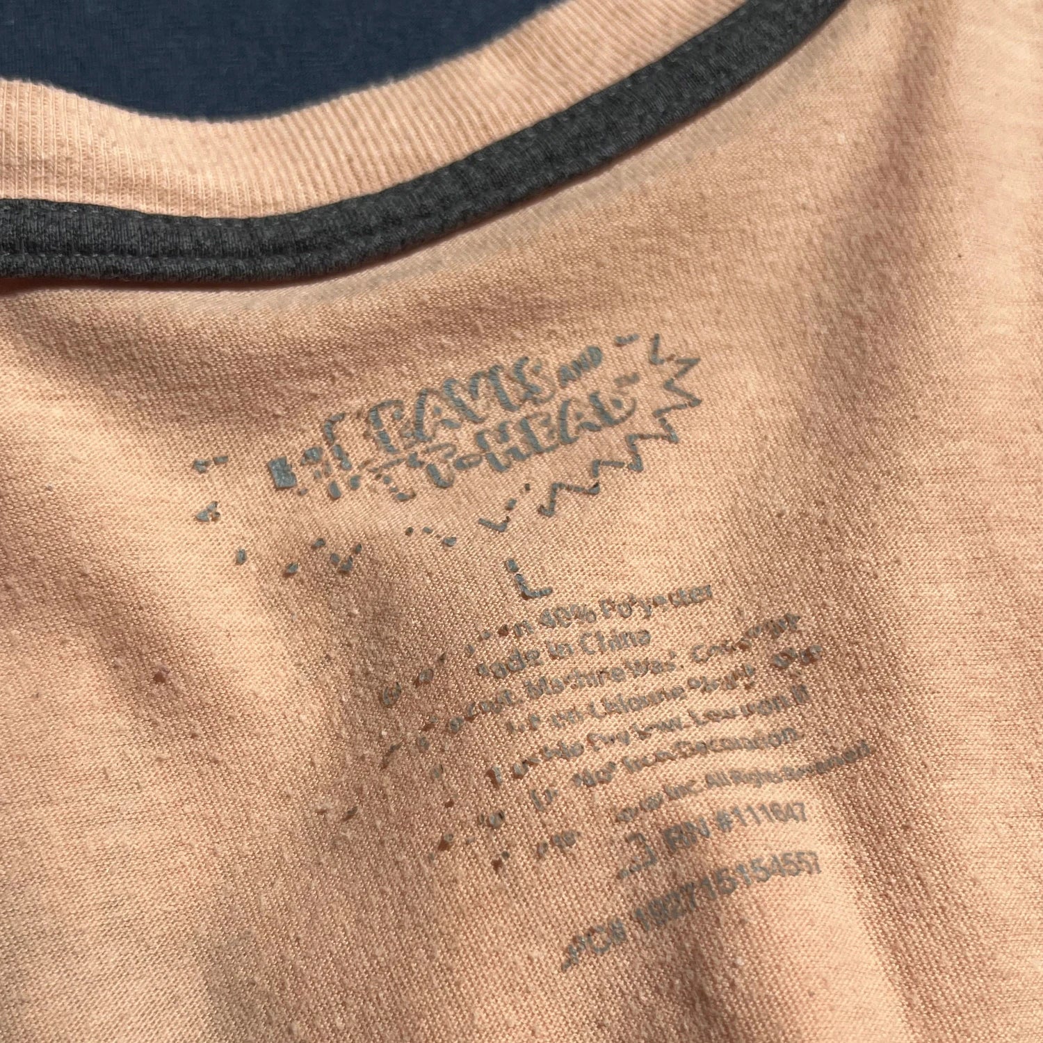 Close-up of Beavis and Butthead Carelabel on beige long sleeve