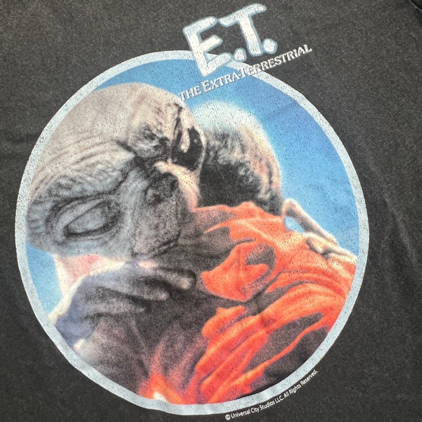 Cotton Blended_A closeup of Elliott and E.T. hugging print and a E.T. logo