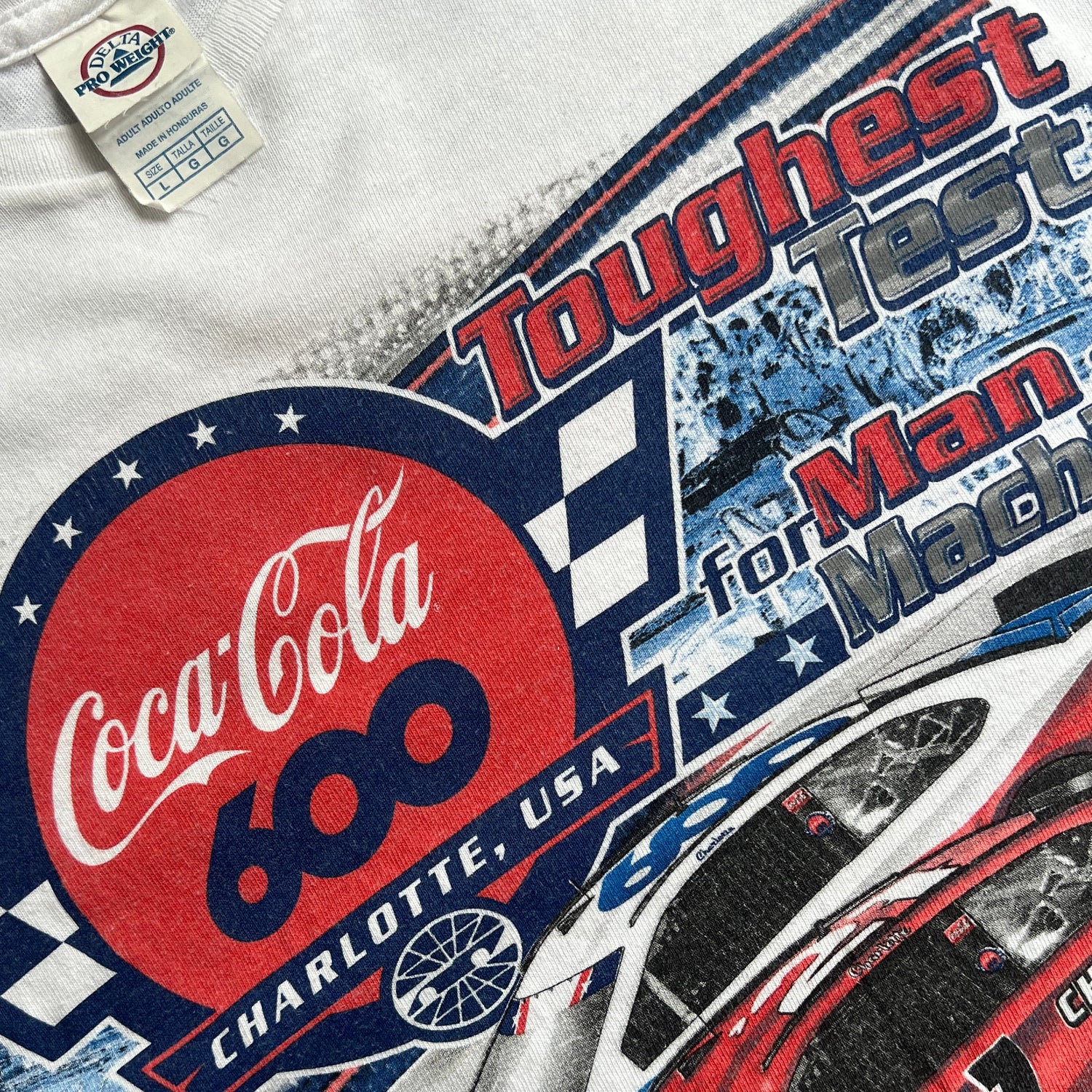 Close-up of a white shirt with Coca-Cola 600 and race car graphic print