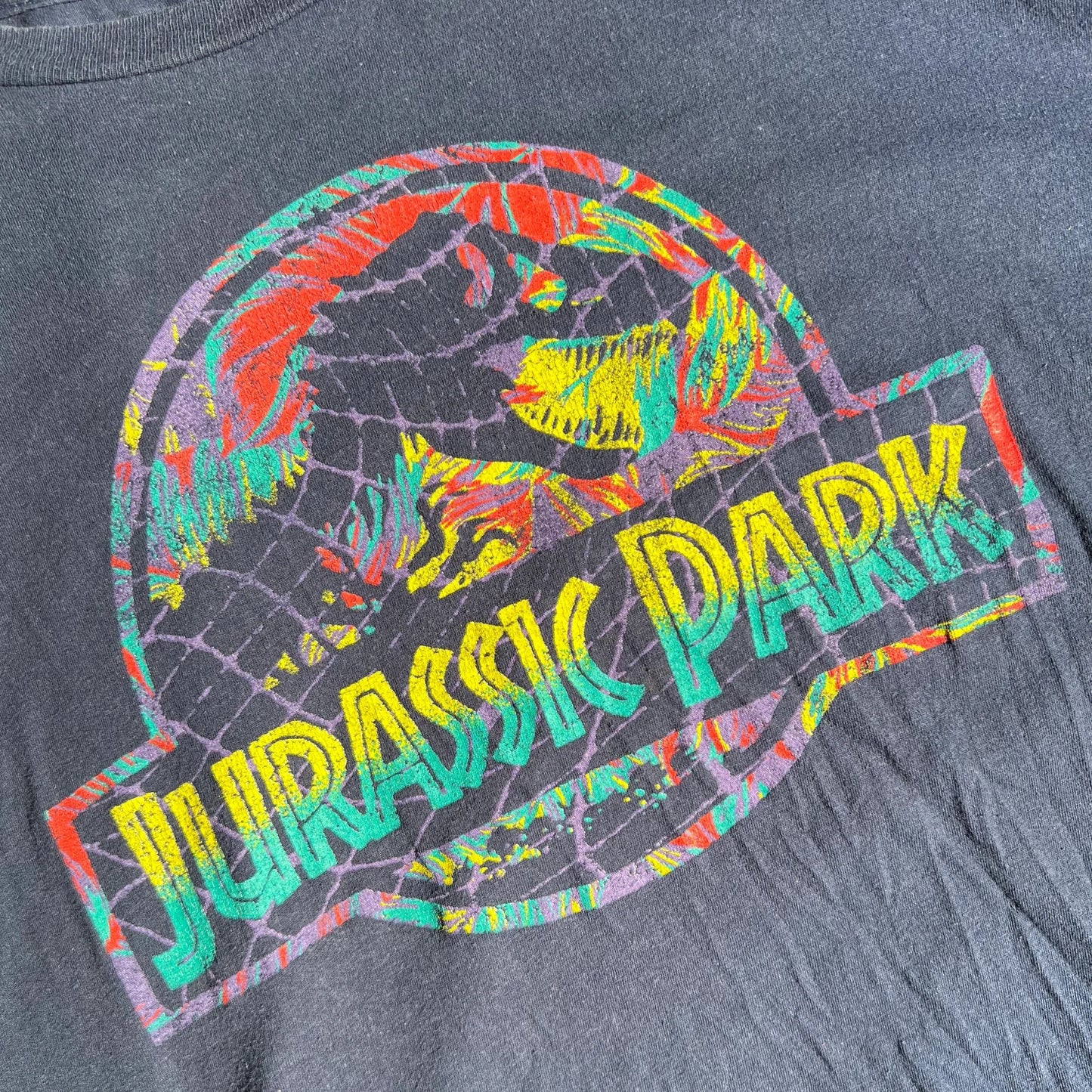 A colorful 'Jurassic Park' logo on a Dark Blue T-shirt