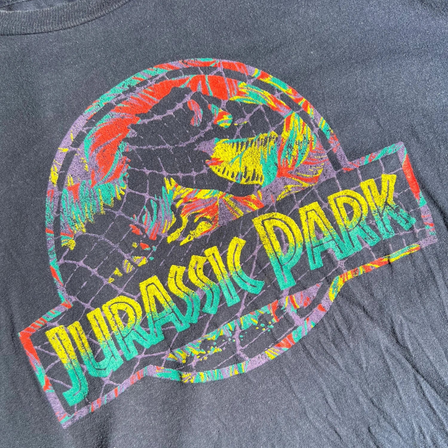 A colorful 'Jurassic Park' logo on a Dark Blue T-shirt