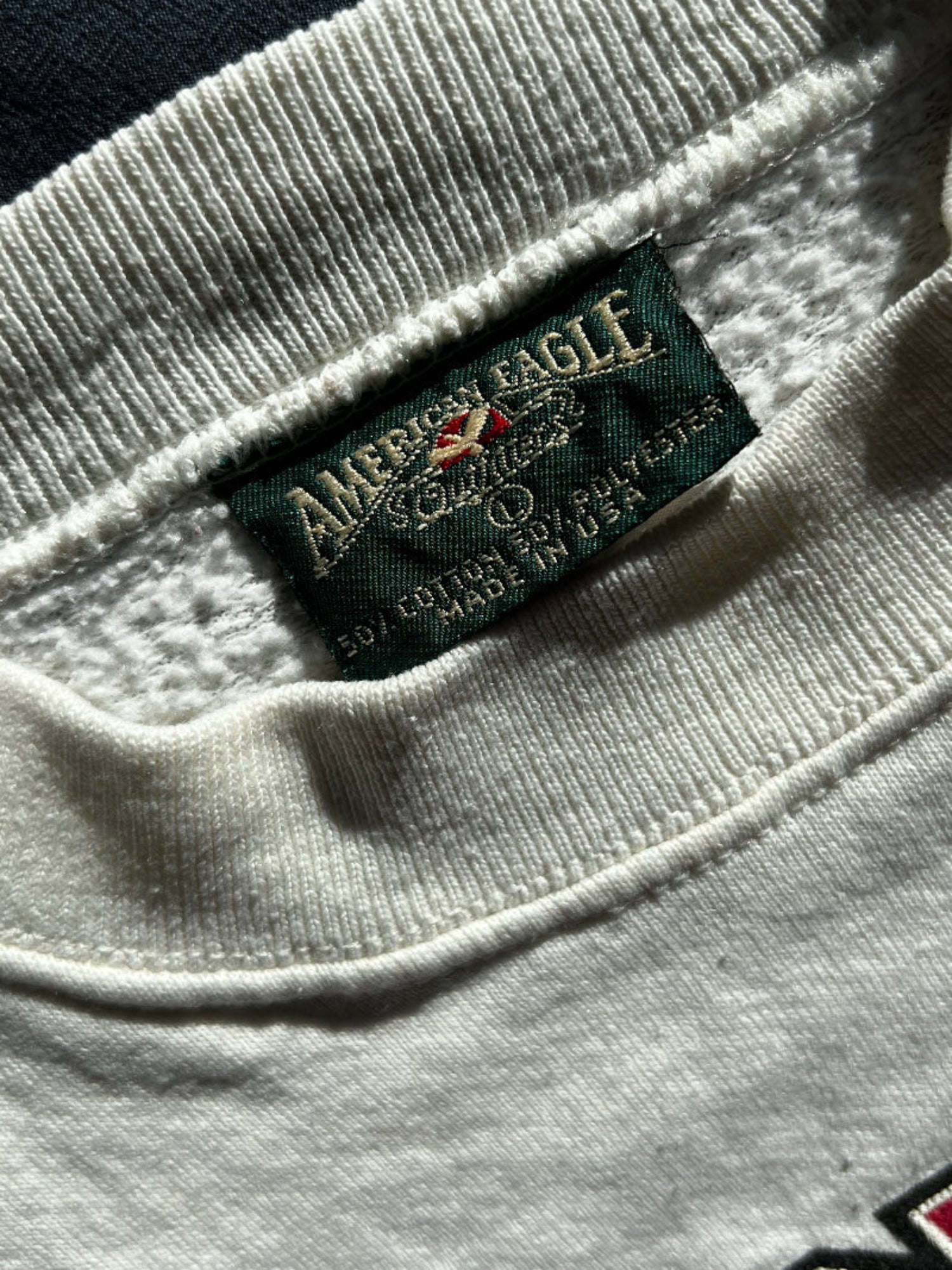 White Cotton and Polyester crewneck sweatshirt and American Eagle logo on a clothing neck label