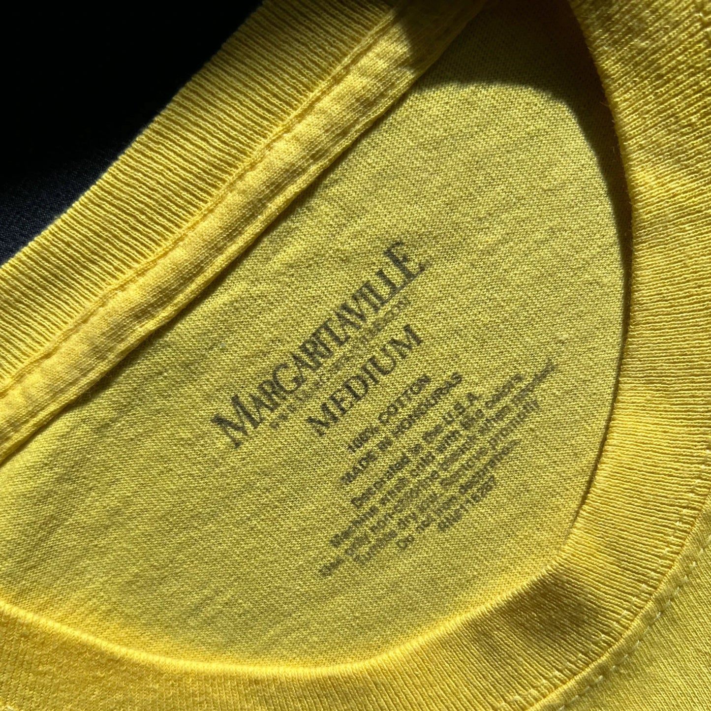 Close-up of Margaritaville yellow t-shirt details