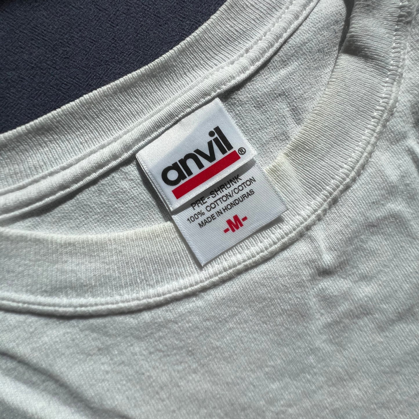 Close-up of an Anvil label on a white T-shirt