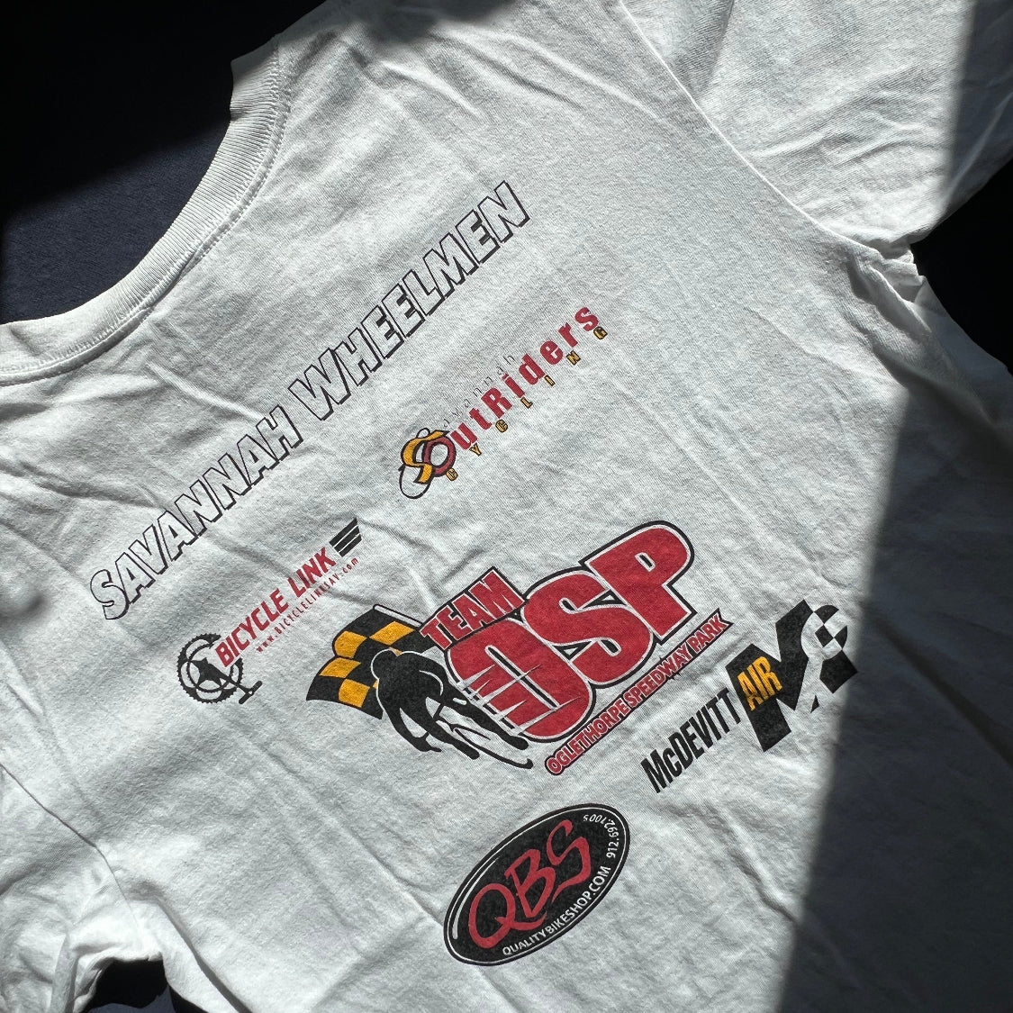 Laid flat_100% cotton white t-shirt with various logos