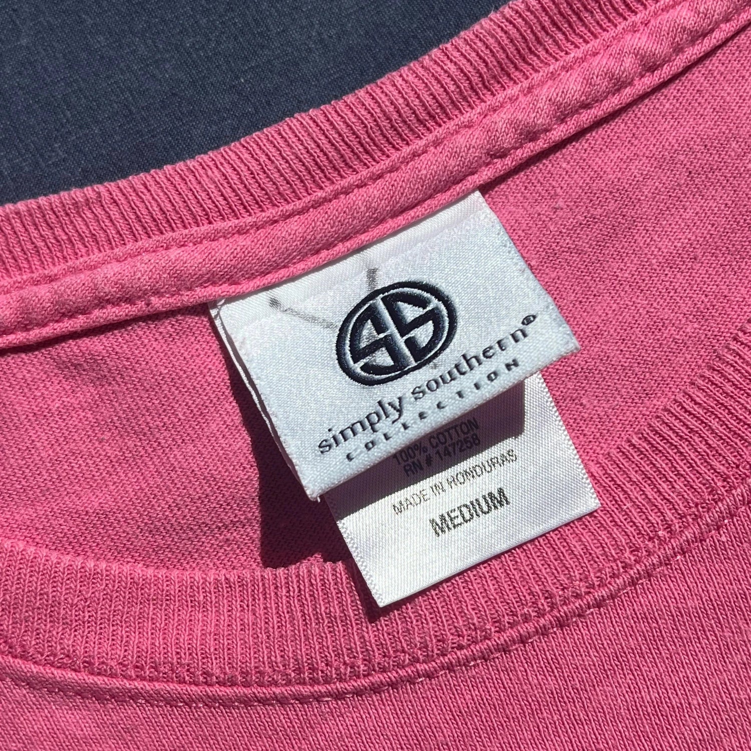 A 'Simply Southern' carelabel on light pink t-shirt