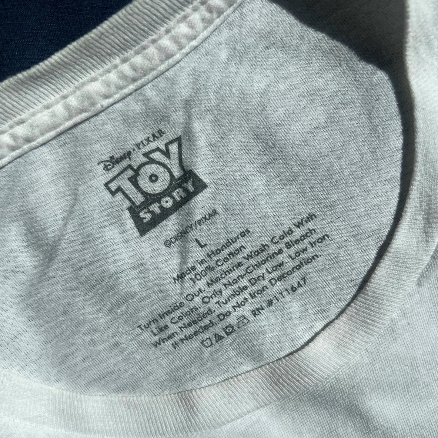 Close-up of White t-shirt with Disney Pixar Toy Story carelabel