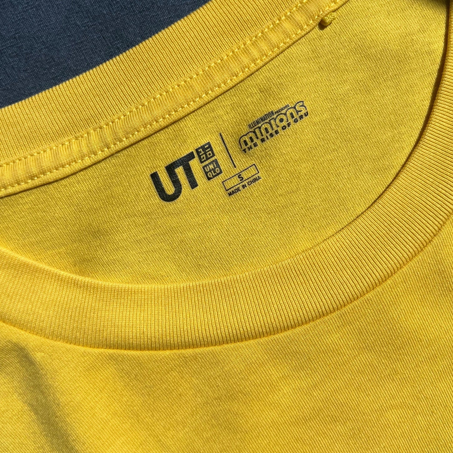 Close-up of a carelabel with UT & Minions logos and information