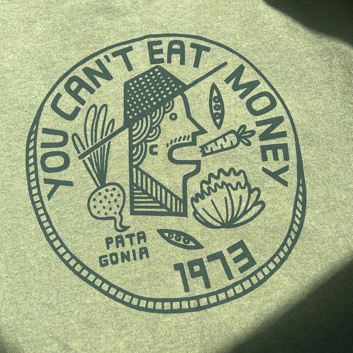 Army green t-shirt with "You Can't Eat Money" wordings and print of farmer 